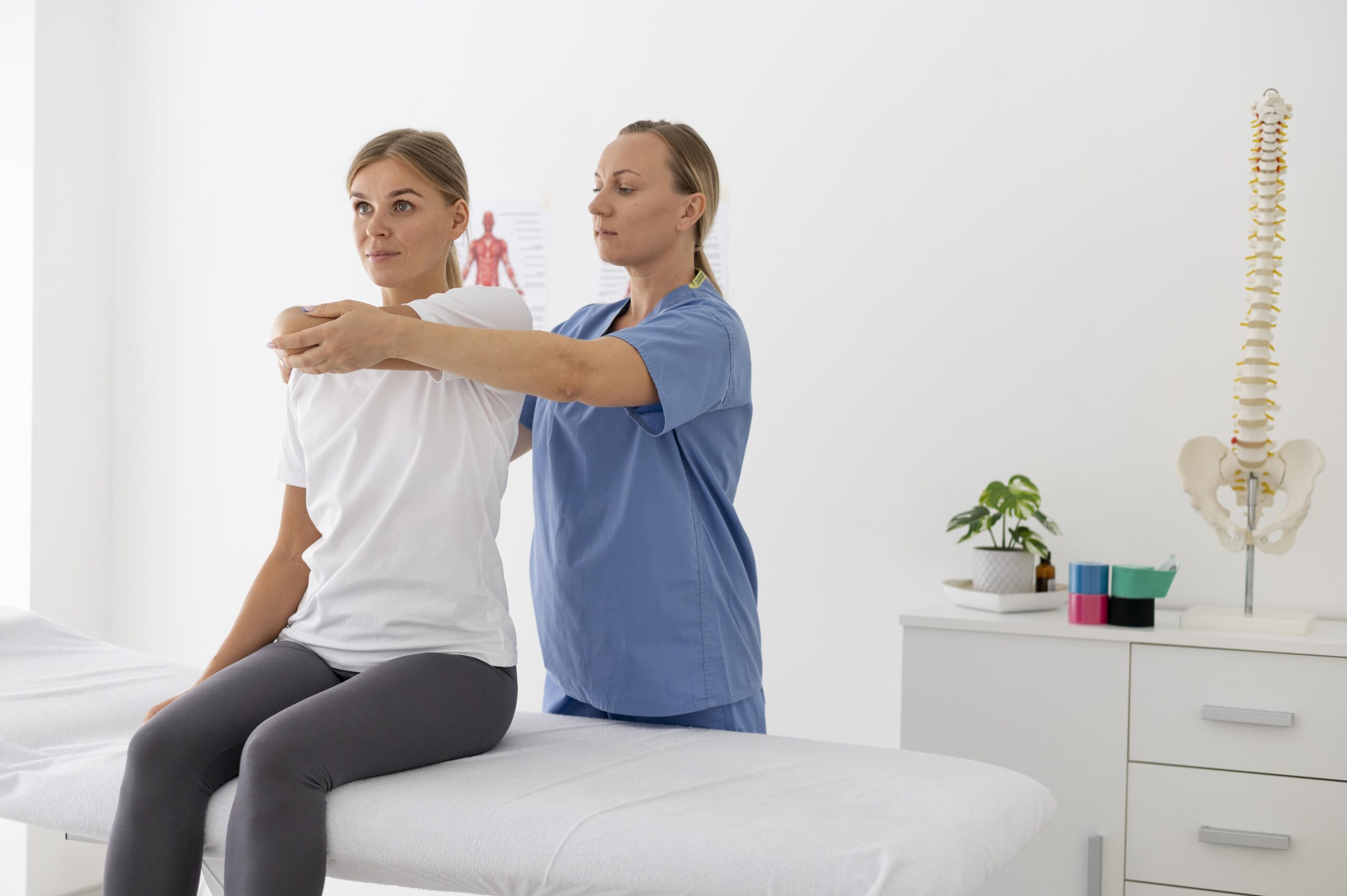 physiotherapist-helping-female-patient-her-clinic physiotherapist-helping-female-patient-her-clinic